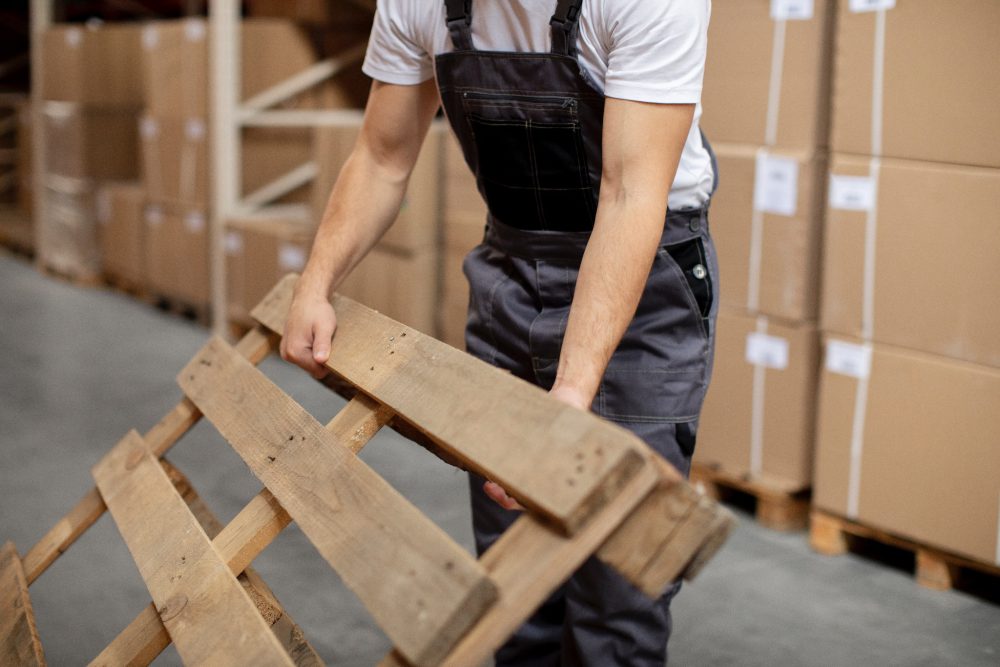 worker shifting pallets