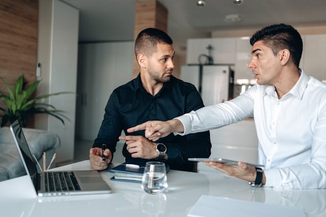 shocked-man-pointing-his-finger-on-the-macbook-pro
